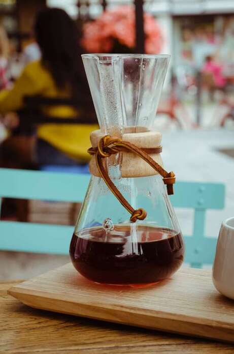 clear chemex containing coffee
