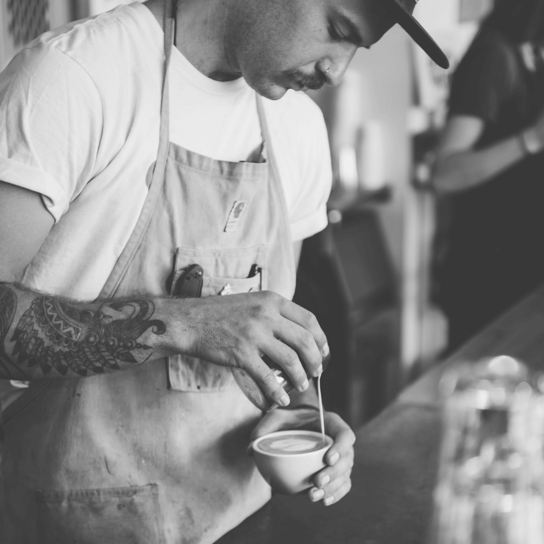 man pouring a flat white in melbourne australia